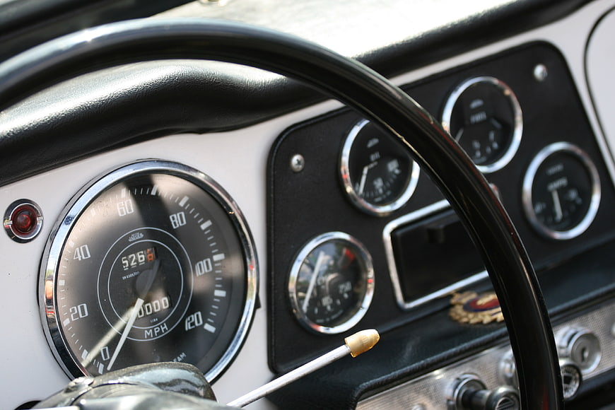 Vintage Car Dashboard with Speedometer and Steering Wheel