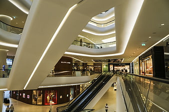Modern Luxury Shopping Mall Interior With Escalators And Storefronts
