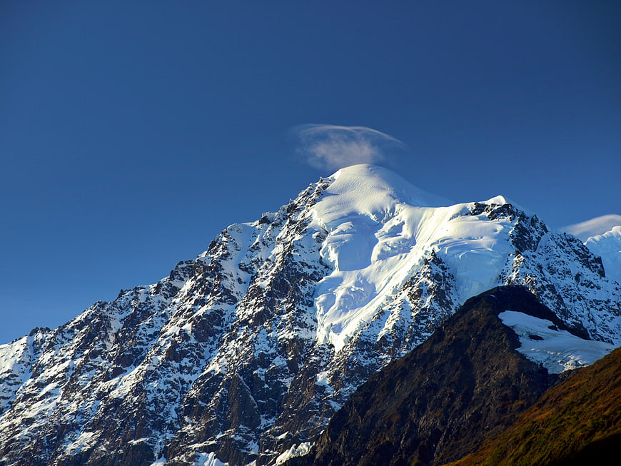 Snow-Capped Mountain Peak with Lenticular Cloud