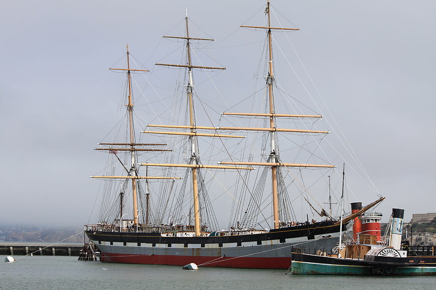 Historic Three-Masted Sailing Ship Docked in Harbor