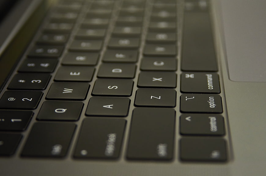 Close-up of laptop keyboard keys and trackpad