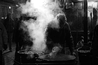 Street Vendor Cooking Chestnuts in Steamy Black and White