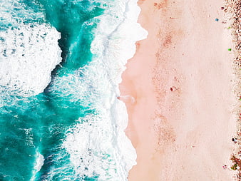 Aerial View of Turquoise Waves Crashing on Sandy Beach