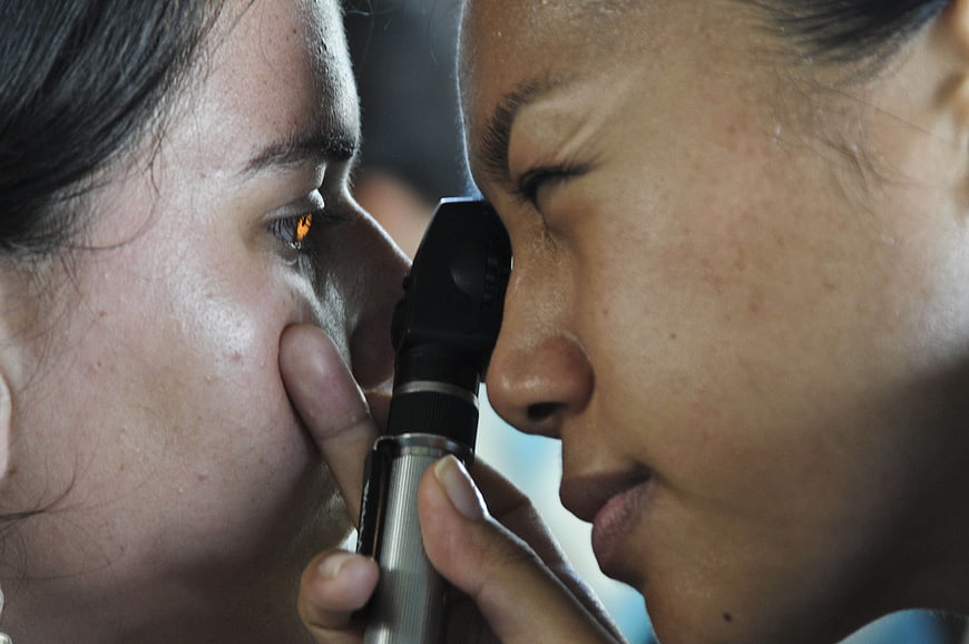 Close-up of optometrist examining patient's eye with medical instrument