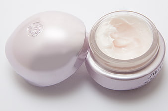 Open Shiseido Eye Cream Jar With Silver Lid On White Background