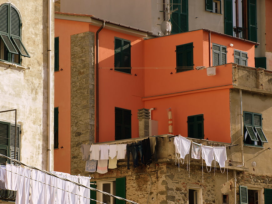 Colorful Mediterranean building facade with hanging laundry