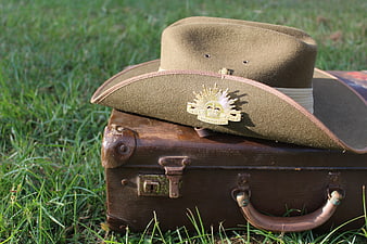 Vintage Australian Army Slouch Hat Resting on Antique Wooden Suitcase