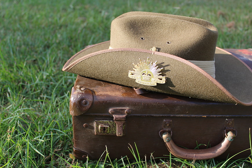 Vintage Australian Army Slouch Hat Resting on Antique Wooden Suitcase