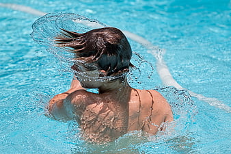 Boy Swimming Backstroke in Outdoor Pool