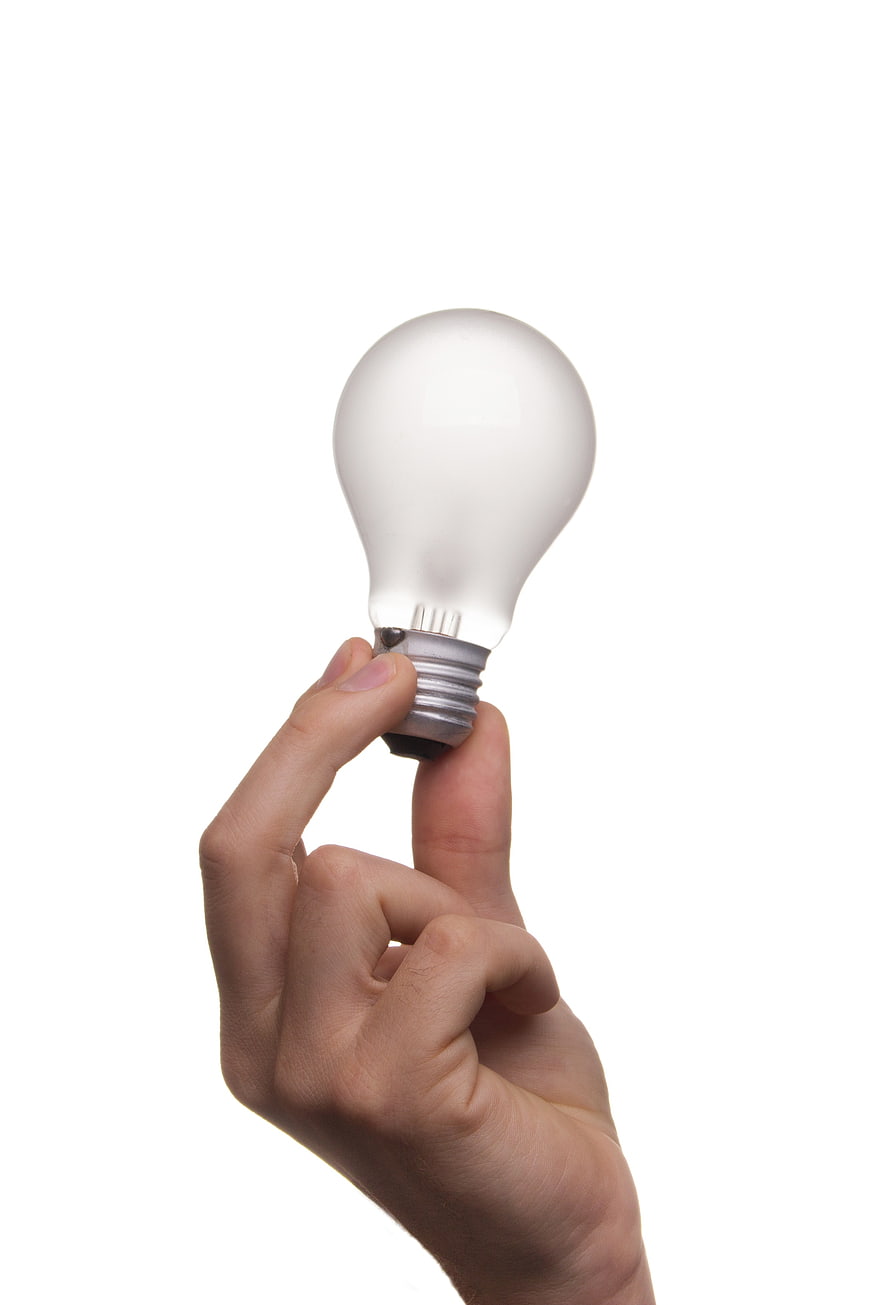 Hand holding light bulb symbolizing idea and innovation