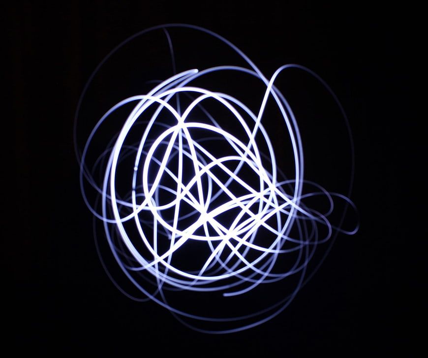 Abstract Blue Light Painting Swirls on Black Background