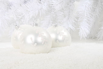 White Christmas Ornaments on Snow with Flocked Tree Branches