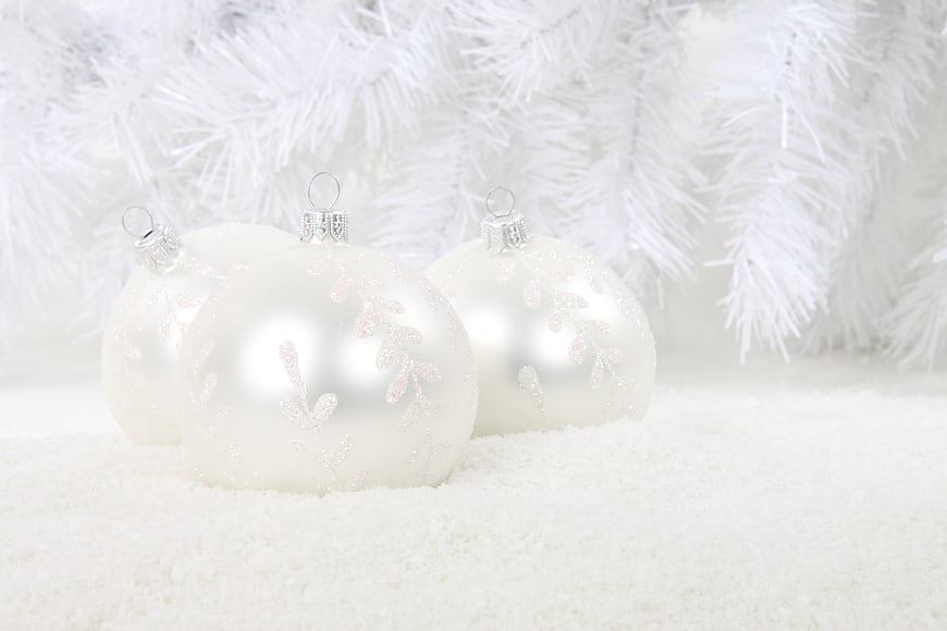 White Christmas Ornaments on Snow with Flocked Tree Branches