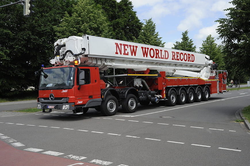 Red Mercedes Fire Truck with World Record Crane on Road