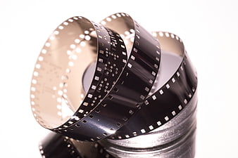 Vintage film reel spool with unspooled negative strip