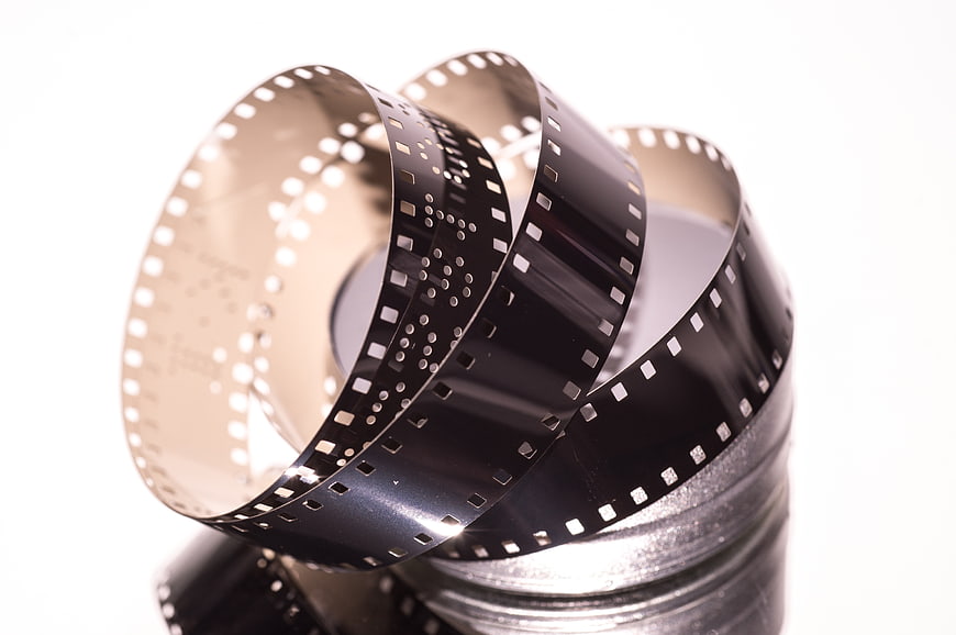 Vintage film reel spool with unspooled negative strip