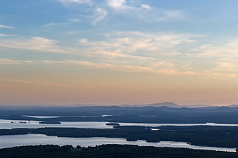 Scenic Lake Landscape with Forested Islands at Sunset