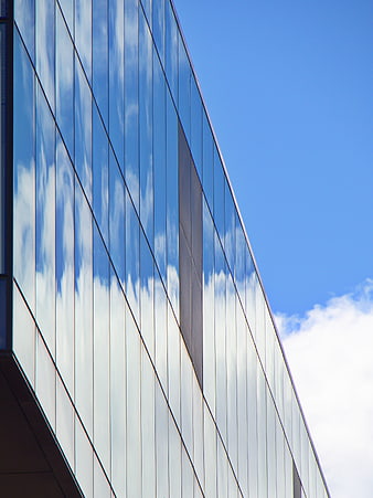 Modern Glass Building Facade with Sky Reflection