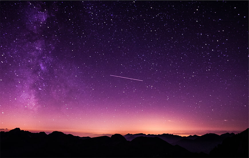 Purple Milky Way Galaxy with Shooting Star over Mountain Silhouette