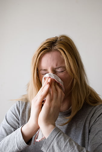 Blonde Woman Blowing Nose With Handkerchief