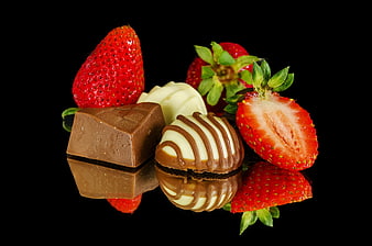 Fresh Strawberries and Gourmet Chocolate on Black Background