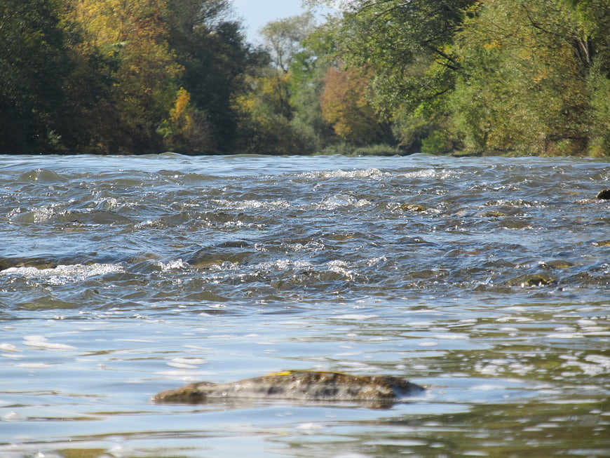 Autumn river landscape with flowing water and colorful foliage