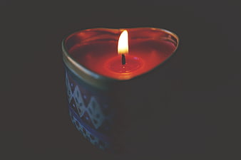 Heart-Shaped Candle Burning in Dark Atmosphere