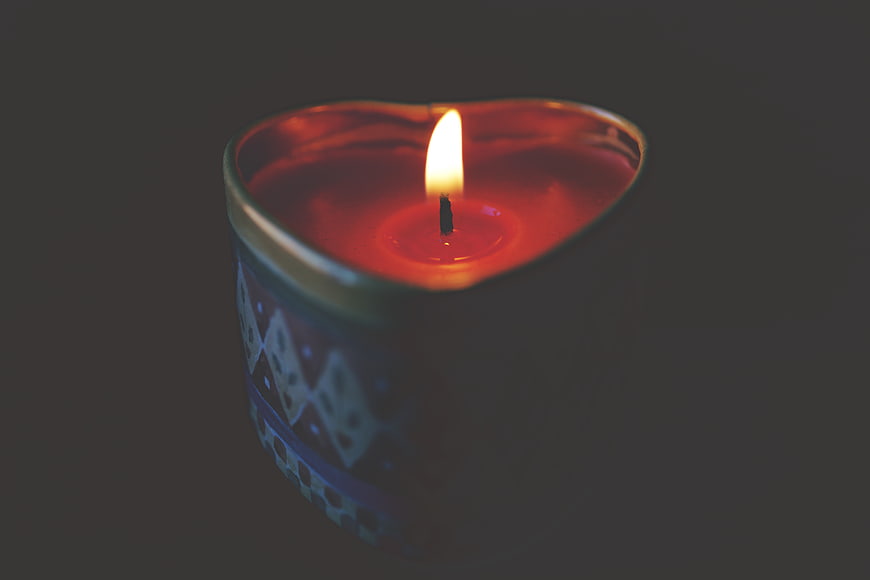 Heart-Shaped Candle Burning in Dark Atmosphere