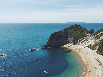 Aerial View of Secluded Beach Cove with Kayak and Cliffs