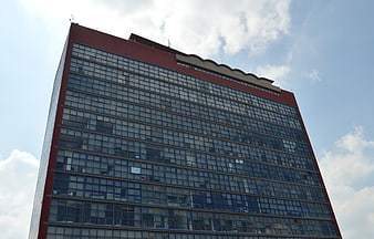 Low angle view of modern red and blue glass office building