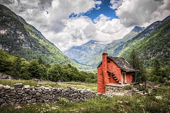 Red Alpine Cottage in Mountain Valley Landscape