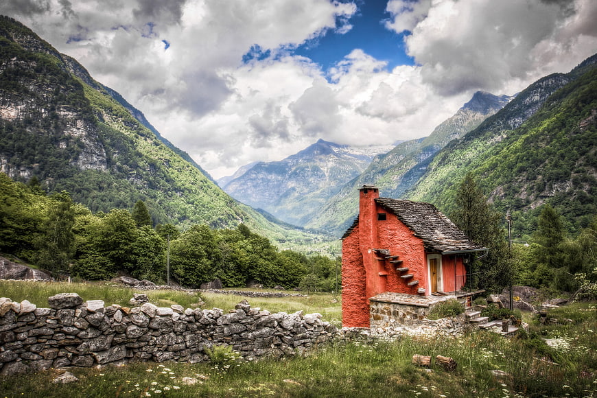 Red Alpine Cottage in Mountain Valley Landscape
