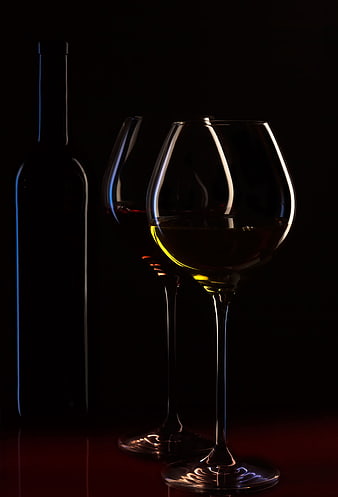 Elegant Wine Glasses and Bottle in Dramatic Low Light