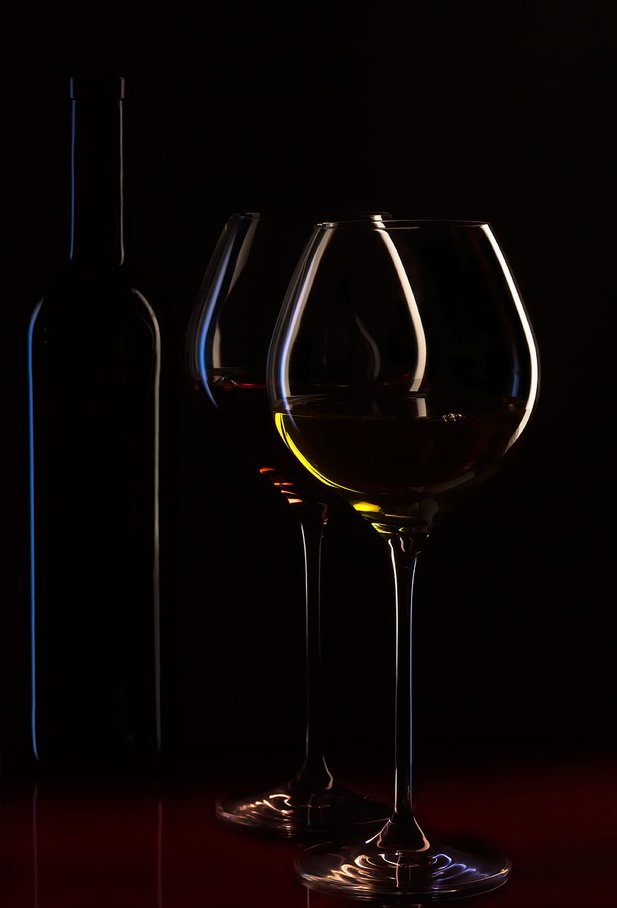 Elegant Wine Glasses and Bottle in Dramatic Low Light