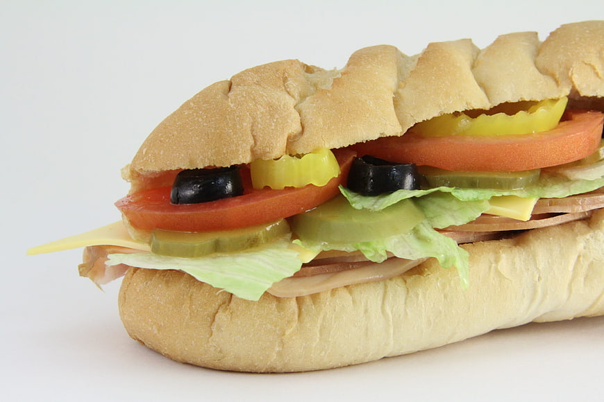 Close-up of a fresh submarine sandwich with ham, cheese, and vegetables