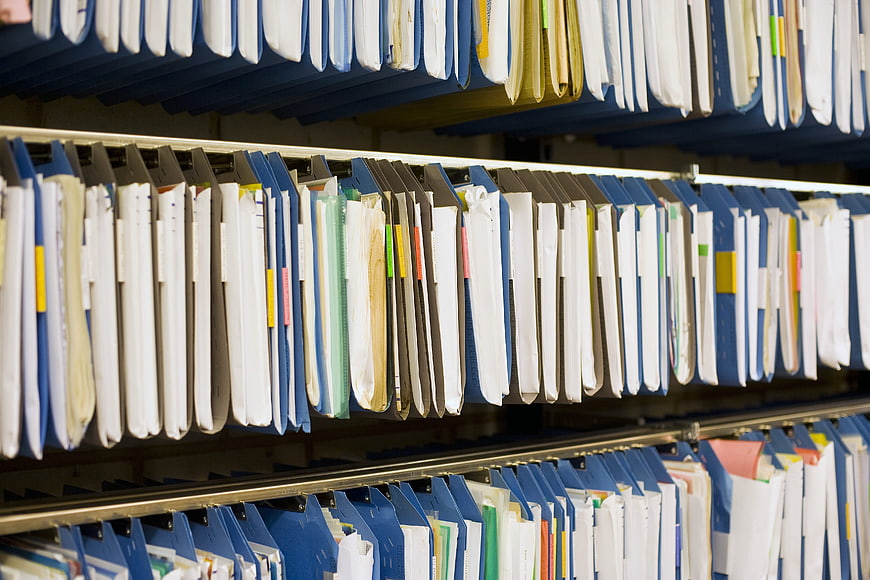 Rows of hanging file folders in a corporate archive