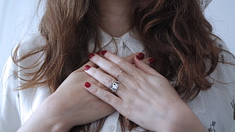 Close-up of Woman's Hands with Red Nails and Silver Ring