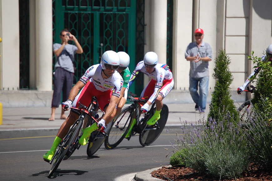 Cyclists racing on a city street during a team time trial