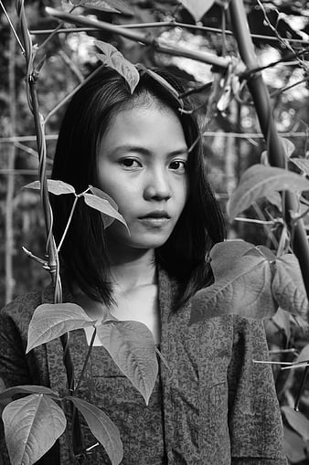 Black and white portrait of a woman in a garden