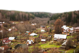 Tilt-shift miniature effect of a rural village in a forest valley