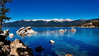 Crystal Clear Blue Lake Tahoe Water with Snowy Mountains