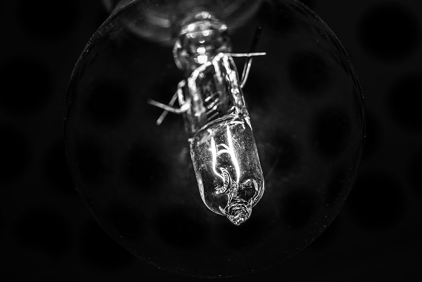 Close-up of vintage light bulb filament in black and white