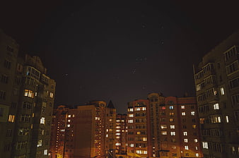 Night Sky with Stars Over Urban Apartment Buildings