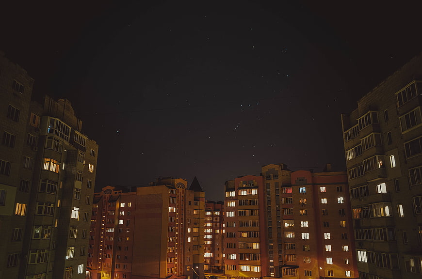 Night Sky with Stars Over Urban Apartment Buildings