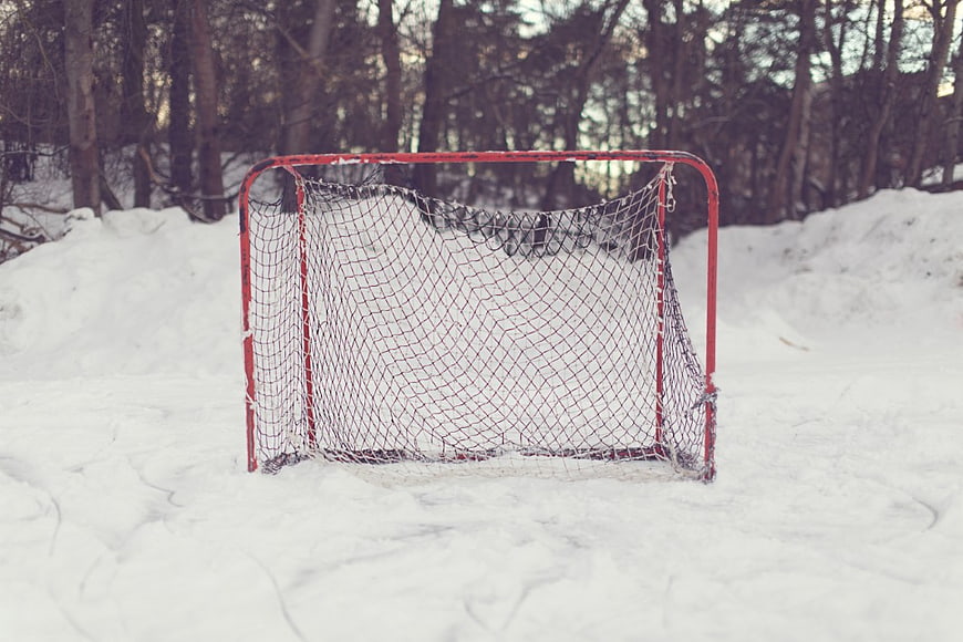 Red Hockey Goal in Snowy Winter Forest