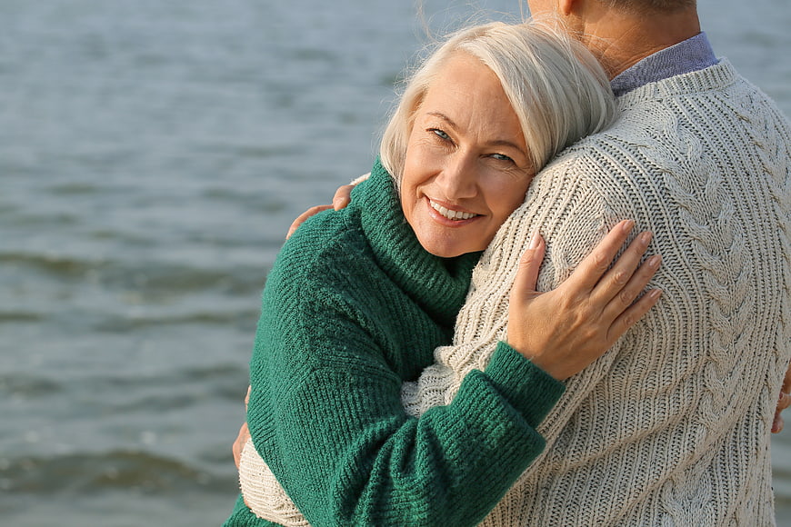 Happy Senior Couple Hugging by the Water