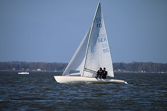 Sailboat with Two Crew Members Sailing on a Lake