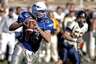 American Football Quarterback Throwing Ball in Blue Jersey