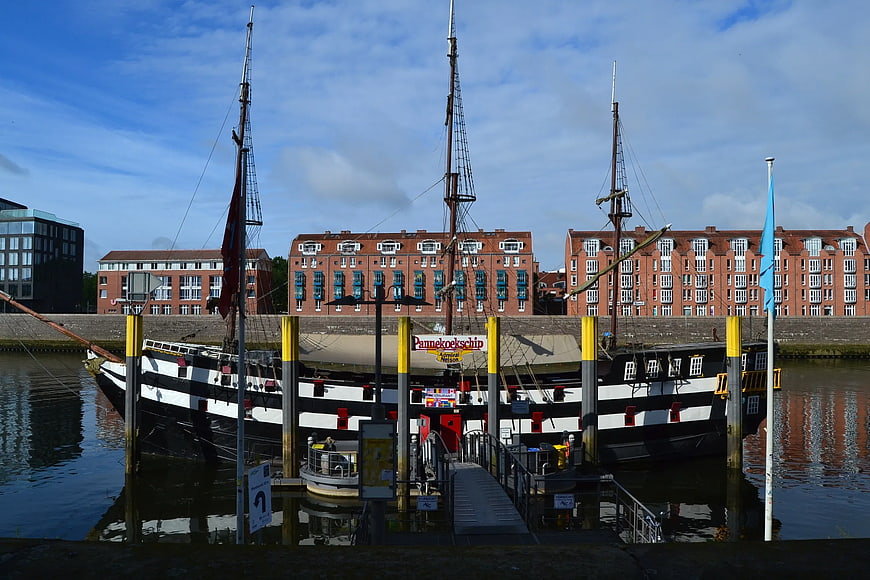 Historic Black and White Sailboat Docked in Harbor