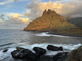 Dramatic coastal landscape with rocky cliffs and ocean waves